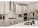A modern kitchen features stainless steel appliances, a sleek gas cooktop, and a white backsplash at 390 Coastal Redwood St, Las Vegas, NV 89138