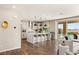 An open kitchen has an island with bar stools, stainless steel appliances, and a backyard pool view at 390 Coastal Redwood St, Las Vegas, NV 89138