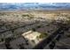 Expansive aerial view of a residential area with mountain views and homes with well-manicured lawns at 3938 E Chaffe Ave, Pahrump, NV 89061