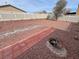 Well-designed backyard with brick patio, decorative rocks, mature landscaping, and a fire pit at 3938 E Chaffe Ave, Pahrump, NV 89061