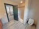 Bright bathroom showcasing tiled floors, a toilet, and a shower-tub combination at 3938 E Chaffe Ave, Pahrump, NV 89061