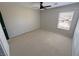 Carpeted bedroom featuring a ceiling fan, natural lighting, and neutral walls at 3938 E Chaffe Ave, Pahrump, NV 89061