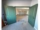 Bonus room offers green doors leading to garage with large garage door and neutral colored walls at 3938 E Chaffe Ave, Pahrump, NV 89061