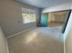 Bonus room offers neutral walls and green doors leading to garage with a window on one side at 3938 E Chaffe Ave, Pahrump, NV 89061