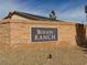 Elegant Burson Ranch community sign displayed on a textured brick wall with stone landscaping, creating a welcoming atmosphere at 3938 E Chaffe Ave, Pahrump, NV 89061