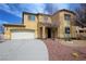 Two-story home with a two-car garage, neutral color, and desert landscaping at 3938 E Chaffe Ave, Pahrump, NV 89061
