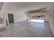Spacious two-car garage with epoxy floor, bright walls and a peek of the home from the outside at 3938 E Chaffe Ave, Pahrump, NV 89061