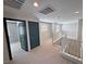 Bright loft with carpet flooring and natural light, featuring staircase with white railings at 3938 E Chaffe Ave, Pahrump, NV 89061