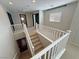 Carpeted staircase with white railings, connecting to the main floor and upper levels at 3938 E Chaffe Ave, Pahrump, NV 89061