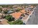 Aerial view showcasing a community with a swimming pool and houses with red-tiled roofs at 3941 Boca Grande Ave, Las Vegas, NV 89120