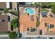 Aerial view of a house with a uniquely-shaped swimming pool and red tiled roof at 3941 Boca Grande Ave, Las Vegas, NV 89120