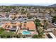 Aerial view showcasing houses with swimming pools and solar panels in a suburban neighborhood at 3941 Boca Grande Ave, Las Vegas, NV 89120