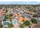 Aerial view showcasing a community swimming pool and houses with many featuring solar panels at 3941 Boca Grande Ave, Las Vegas, NV 89120