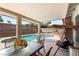 Backyard featuring a covered patio area with an inviting pool beyond at 3941 Boca Grande Ave, Las Vegas, NV 89120