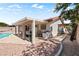 Inviting backyard featuring a covered patio with grill, dining area, and a well-maintained, sparkling blue swimming pool at 3941 Boca Grande Ave, Las Vegas, NV 89120