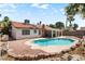 Charming backyard with a sparkling pool, mature landscaping, and covered patio offers a great space for entertaining at 3941 Boca Grande Ave, Las Vegas, NV 89120