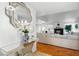 Hallway features modern mirrored table and decorative mirror, with a view into the adjacent living room at 3941 Boca Grande Ave, Las Vegas, NV 89120