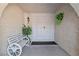 Inviting front entrance featuring a quaint bench, a decorative plant, and a classic white double-door at 3941 Boca Grande Ave, Las Vegas, NV 89120