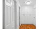 Hallway featuring hardwood floors and white cabinets providing ample storage solutions at 3941 Boca Grande Ave, Las Vegas, NV 89120