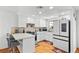 Bright kitchen with white cabinets, a breakfast bar, and modern stainless steel appliances at 3941 Boca Grande Ave, Las Vegas, NV 89120