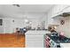 Bright kitchen space connecting to a dining area with wood floors and neutral decor at 3941 Boca Grande Ave, Las Vegas, NV 89120