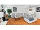 Bright living room with hardwood floors, a decorative fireplace, and a plush sectional couch with stylish decor at 3941 Boca Grande Ave, Las Vegas, NV 89120