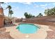 Inviting pool area with mature palm trees offering shade, next to a covered patio for lounging and relaxation at 3941 Boca Grande Ave, Las Vegas, NV 89120