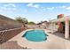 Backyard showcases a pristine pool with a surrounding concrete patio and stacked brick accents for visual appeal at 3941 Boca Grande Ave, Las Vegas, NV 89120
