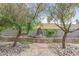 Landscaped backyard with mature trees and decorative water feature and sitting area at 3989 Parkhaven Dr, Las Vegas, NV 89120