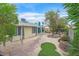 View of the backyard featuring a patio, stone landscaping, and grass at 3989 Parkhaven Dr, Las Vegas, NV 89120