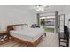 Sunlit bedroom with wood floors, neutral walls, and sliding glass doors to the backyard at 3989 Parkhaven Dr, Las Vegas, NV 89120