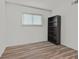 Bedroom with wood floors and a large window has a bookshelf for added storage at 3989 Parkhaven Dr, Las Vegas, NV 89120