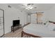This bedroom features a ceiling fan, wood floors, and a barn door to the ensuite bathroom at 3989 Parkhaven Dr, Las Vegas, NV 89120