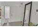 Bright foyer featuring neutral tile flooring, a large mirror, and an exterior-lit front door at 3989 Parkhaven Dr, Las Vegas, NV 89120