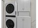 Bright laundry room with a stacked washer and dryer plus ample cabinet storage at 3989 Parkhaven Dr, Las Vegas, NV 89120