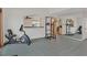 Open living room area with exercise equipment and mirrored wall reflecting the kitchen area at 3989 Parkhaven Dr, Las Vegas, NV 89120
