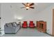 Bright living room featuring a red-brick fireplace, gray sofa, and two red arm chairs at 3989 Parkhaven Dr, Las Vegas, NV 89120