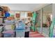 Enclosed sunroom currently used for storage with slider, shelves, and boxes at 3989 Parkhaven Dr, Las Vegas, NV 89120