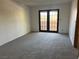 Bright bedroom with plush carpeting, neutral walls, and a door leading to a private balcony at 4121 Gannet Cir # 414, Las Vegas, NV 89103