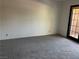 Neutral bedroom with plush carpeting and a sliding glass door for natural light and access to the outside at 4121 Gannet Cir # 414, Las Vegas, NV 89103