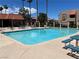 Community swimming pool with clear blue water, tables, and chairs, ideal for cooling off on hot days at 4121 Gannet Cir # 414, Las Vegas, NV 89103