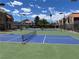 View of the community tennis and pickle ball courts, surrounded by lush landscaping and blue skies at 4121 Gannet Cir # 414, Las Vegas, NV 89103