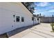 Exterior view of backyard with a patio area, white siding, and partial fencing at 4186 Toronto Cir, Las Vegas, NV 89121
