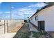 Backyard showcasing partial fencing, desert landscaping and the home's exterior at 4186 Toronto Cir, Las Vegas, NV 89121