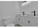 Modern bathroom with double sinks, white cabinets, and contemporary fixtures at 4186 Toronto Cir, Las Vegas, NV 89121