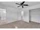 Spacious bedroom includes carpet, fan, and doorway leading to bright bathroom at 4186 Toronto Cir, Las Vegas, NV 89121