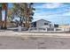 Charming home featuring a white picket fence, mature trees, and a well-maintained yard at 4186 Toronto Cir, Las Vegas, NV 89121