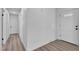 Hallway leading to the front door with white walls, hardwood floors, and modern fixtures at 4186 Toronto Cir, Las Vegas, NV 89121