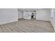 Open-concept living room with hardwood floors flows seamlessly into a modern kitchen with white cabinets at 4186 Toronto Cir, Las Vegas, NV 89121