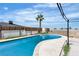 Outdoor pool with clear water, surrounded by concrete and a fence. Tall palm tree in the background at 4186 Toronto Cir, Las Vegas, NV 89121